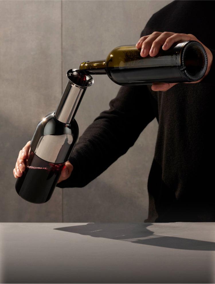 A man pours wine into the ETO decanter