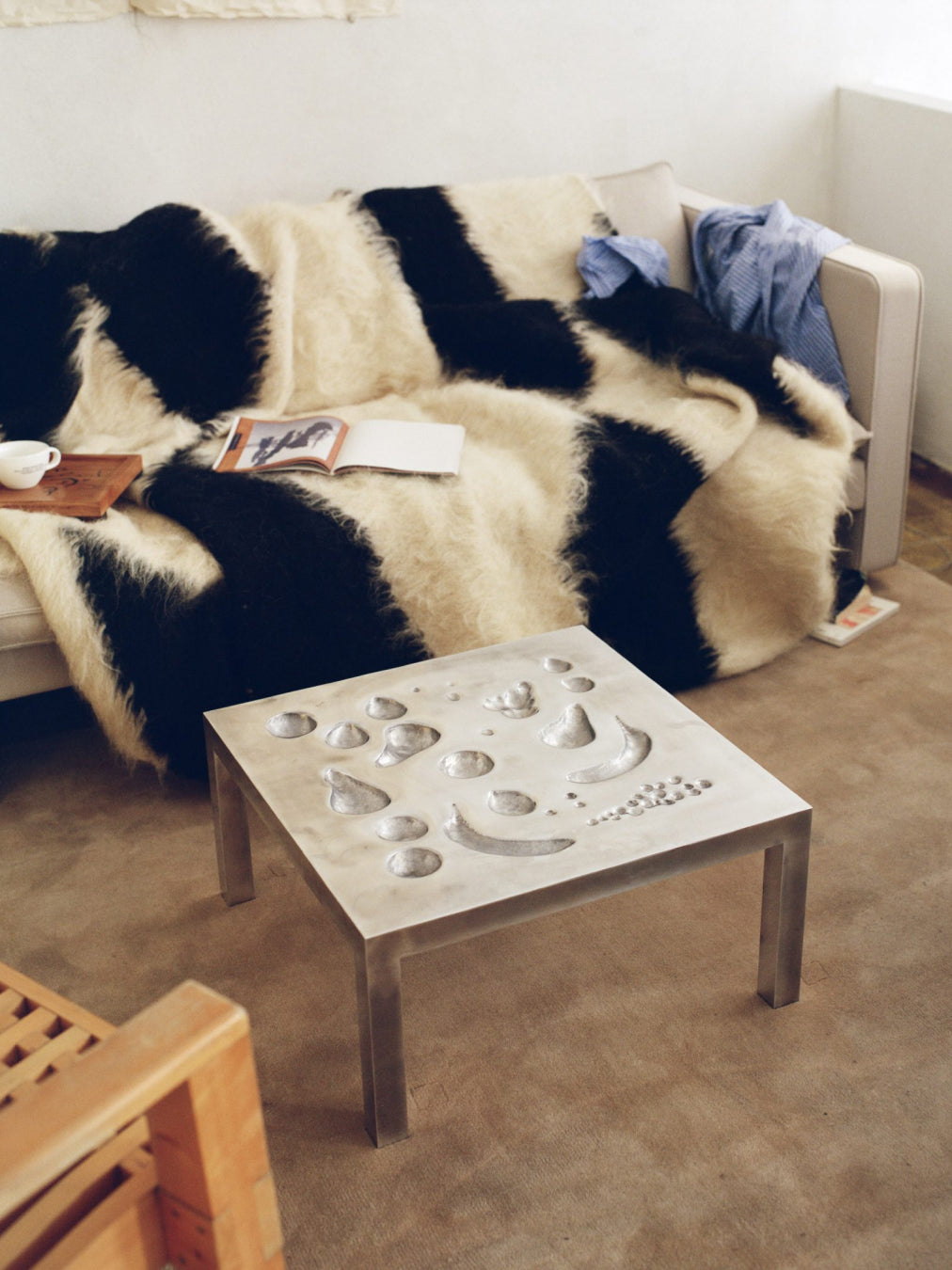 Living room with a patterned sofa, coffee table, and decorative items.