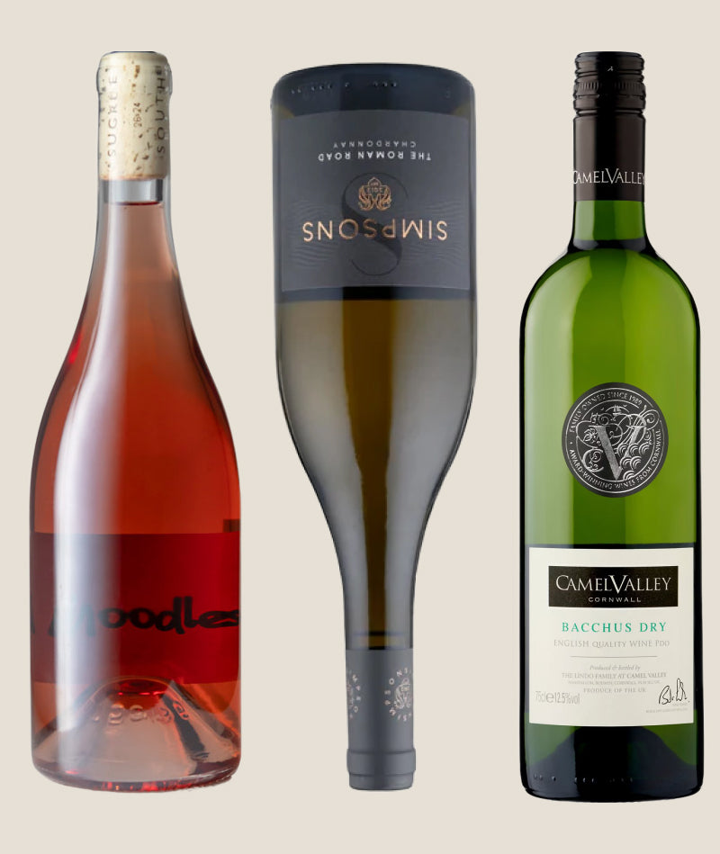 Three wine bottles from different brands on a beige background