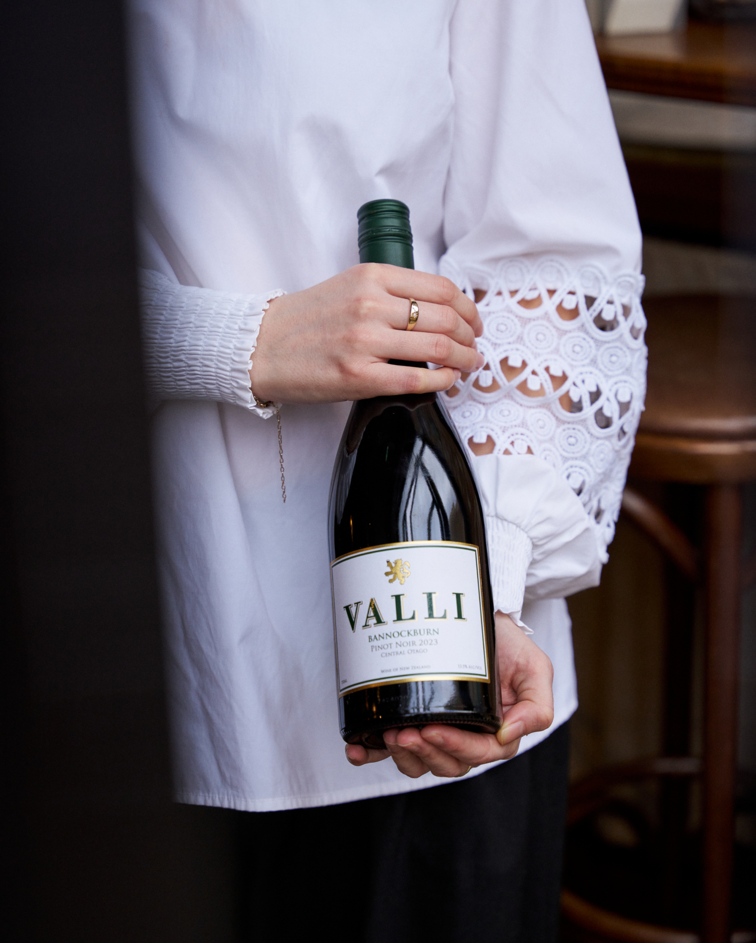 Person holding a bottle of Valli wine with a blurred background